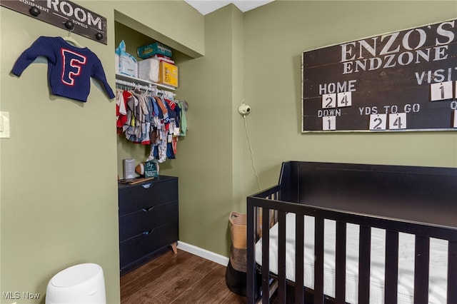 bedroom with dark hardwood / wood-style flooring