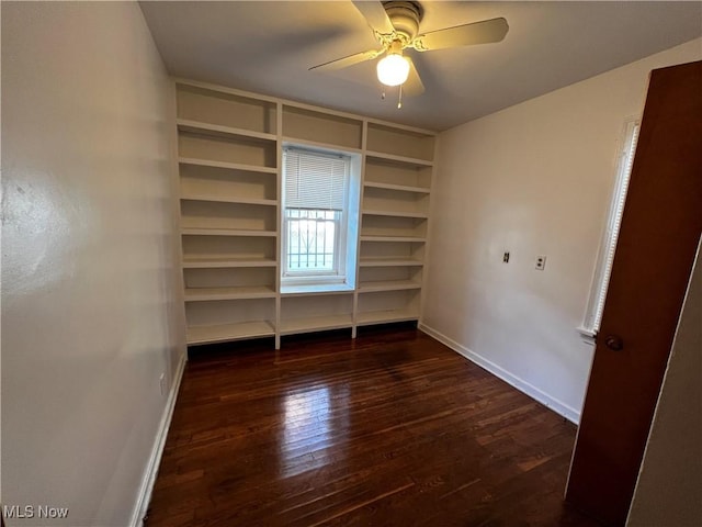 unfurnished bedroom featuring dark hardwood / wood-style floors and ceiling fan