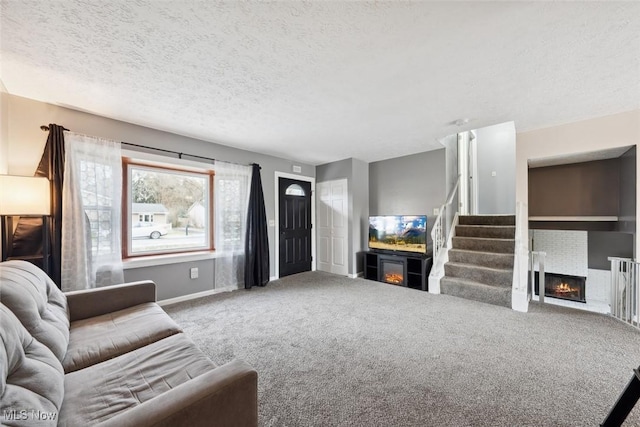 carpeted living room with a textured ceiling