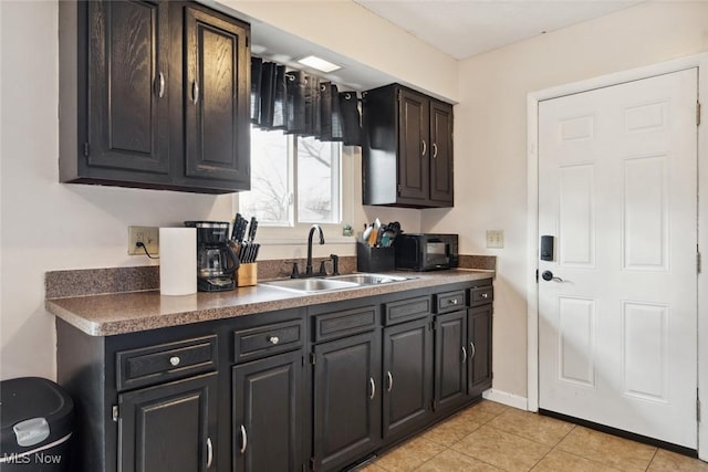 kitchen featuring sink and light tile patterned floors