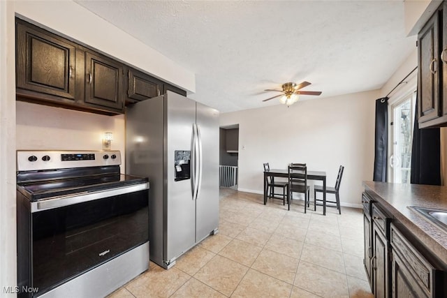 kitchen with dark brown cabinetry, stainless steel appliances, and a textured ceiling