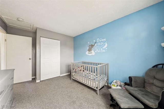 carpeted bedroom featuring a crib and a closet