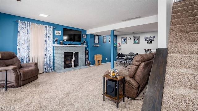 living room with carpet flooring, a fireplace, and a textured ceiling