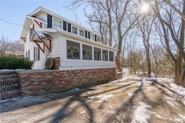 view of side of home with a sunroom