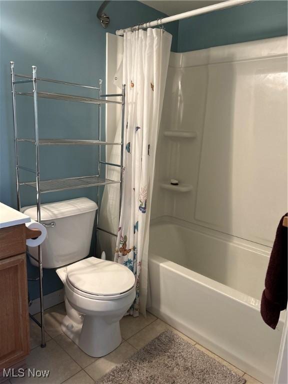 full bathroom featuring vanity, tile patterned floors, shower / bath combination with curtain, and toilet