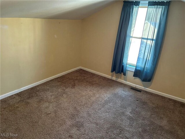 bonus room featuring carpet flooring and vaulted ceiling