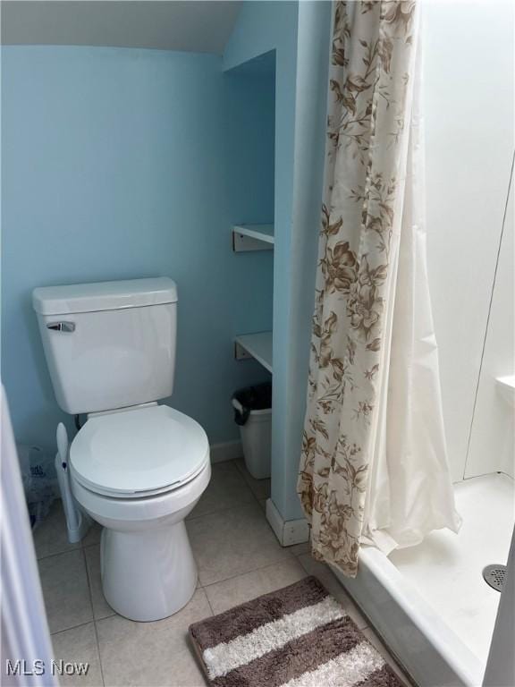 bathroom with tile patterned flooring and toilet