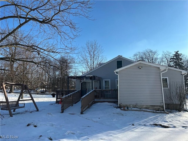 view of snow covered exterior featuring a deck