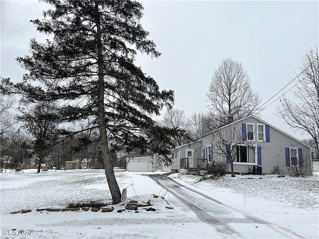 snow covered property with central AC