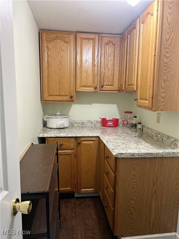 kitchen with dark wood-type flooring