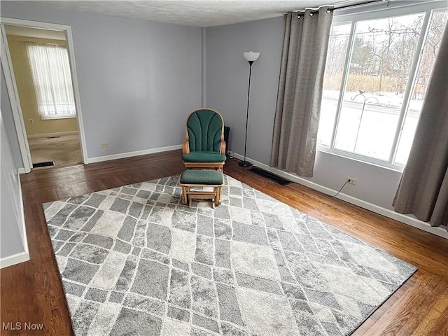 unfurnished room featuring wood-type flooring and a textured ceiling