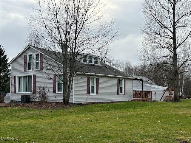 rear view of property featuring a yard and a deck