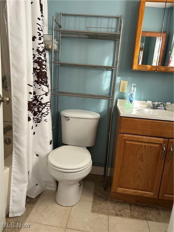 full bathroom featuring vanity, tile patterned flooring, shower / bath combination with curtain, and toilet