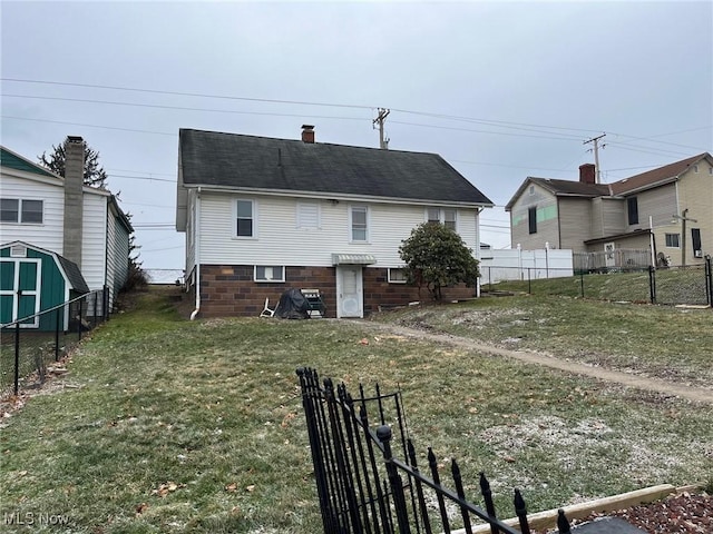 back of property featuring roof with shingles, fence, and a lawn