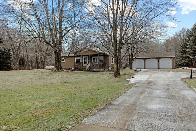 view of front facade featuring a garage, a front yard, and a porch