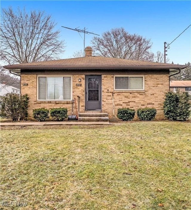 ranch-style home with a front lawn