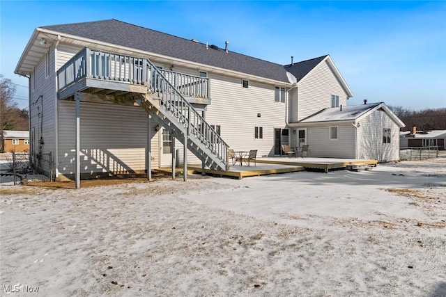 rear view of property featuring a wooden deck