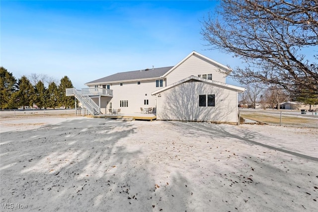 back of property with a wooden deck