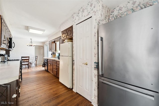 kitchen featuring a notable chandelier, dark hardwood / wood-style floors, and appliances with stainless steel finishes