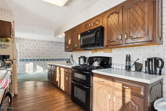 kitchen featuring dark hardwood / wood-style flooring and black appliances