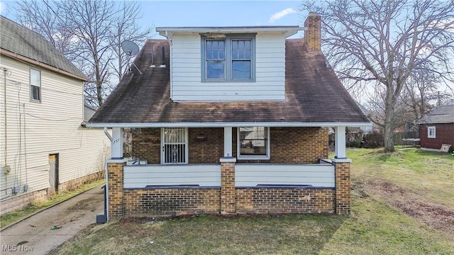 exterior space with a porch and a yard