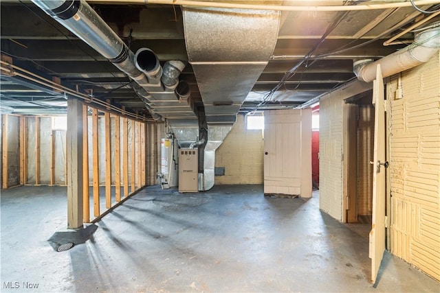 basement featuring water heater and heating unit