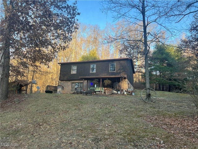 rear view of property with a lawn