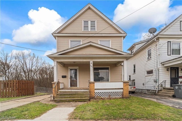 front of property with covered porch and a front yard