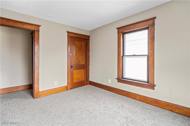 unfurnished bedroom with light carpet and a textured ceiling