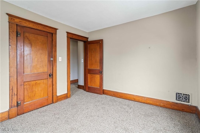 unfurnished bedroom featuring light carpet