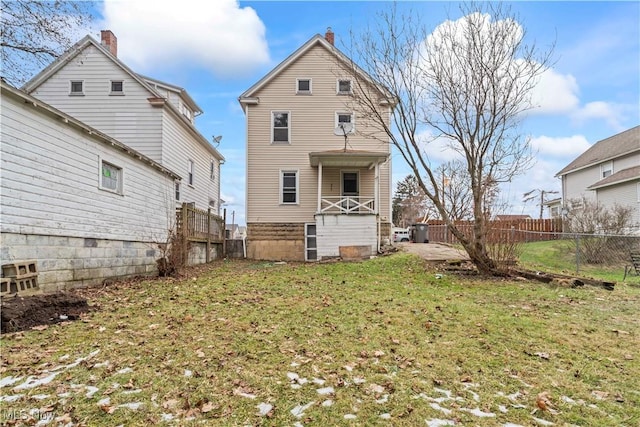 rear view of property featuring a yard