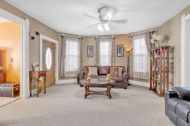 carpeted living room featuring ceiling fan