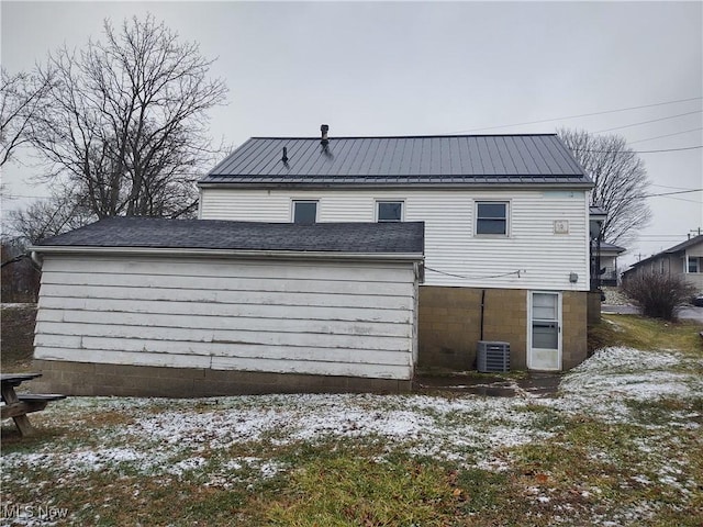 snow covered property with cooling unit