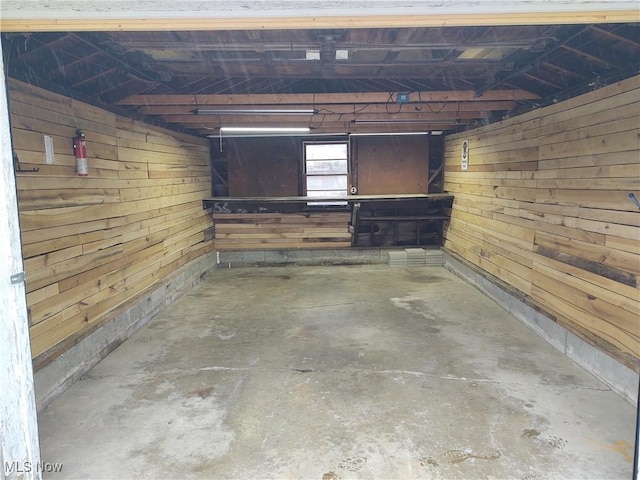 basement featuring wood walls