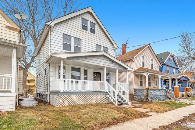 view of front of property with covered porch and a front lawn