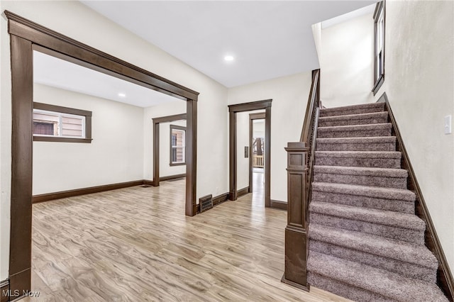 staircase featuring wood-type flooring