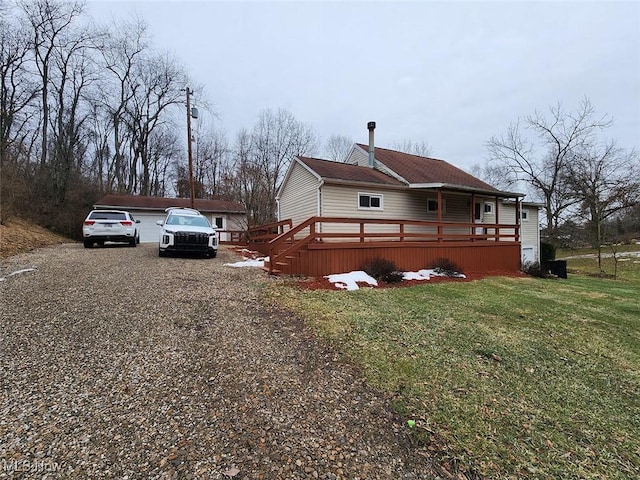 view of property exterior featuring a wooden deck and a yard