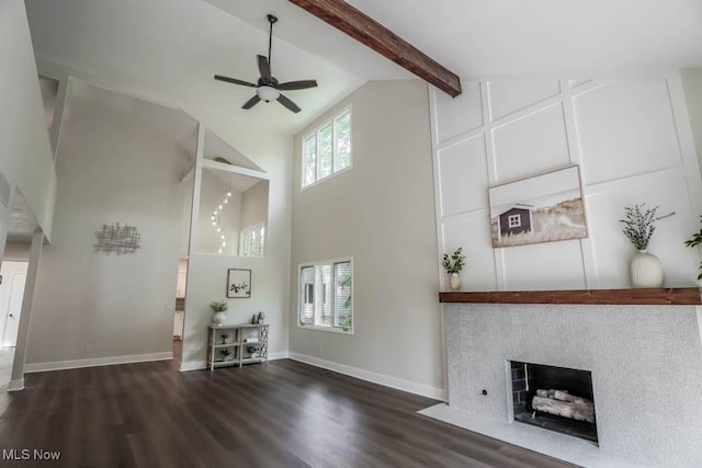 unfurnished living room with beam ceiling, dark hardwood / wood-style flooring, ceiling fan, and high vaulted ceiling