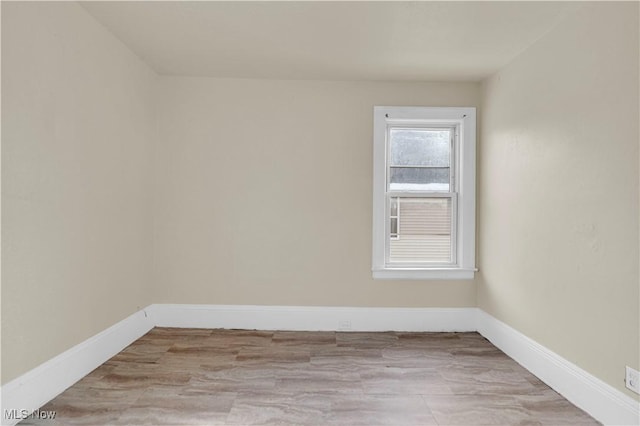 unfurnished room with light wood-type flooring