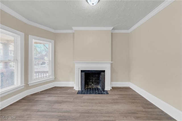 unfurnished living room with ornamental molding, a textured ceiling, and light wood-type flooring