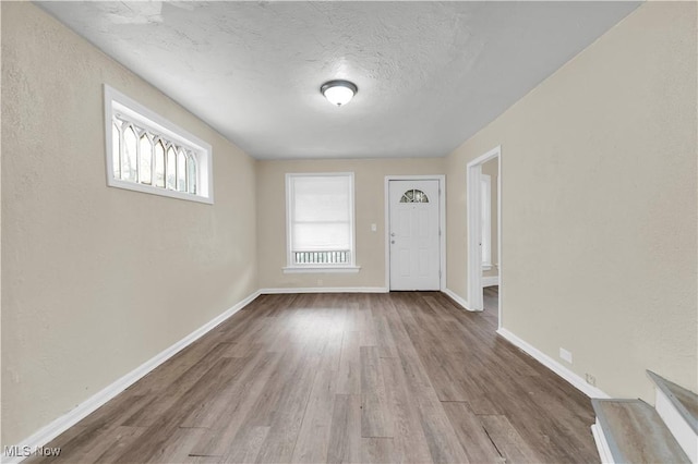 entrance foyer featuring wood-type flooring and a textured ceiling