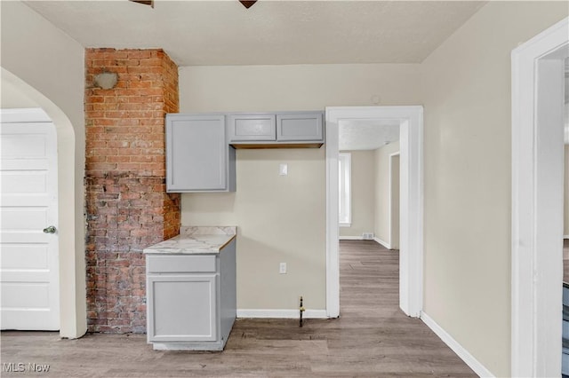 kitchen featuring gray cabinets and light hardwood / wood-style floors