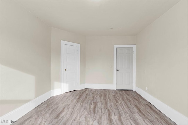 unfurnished room with light hardwood / wood-style floors