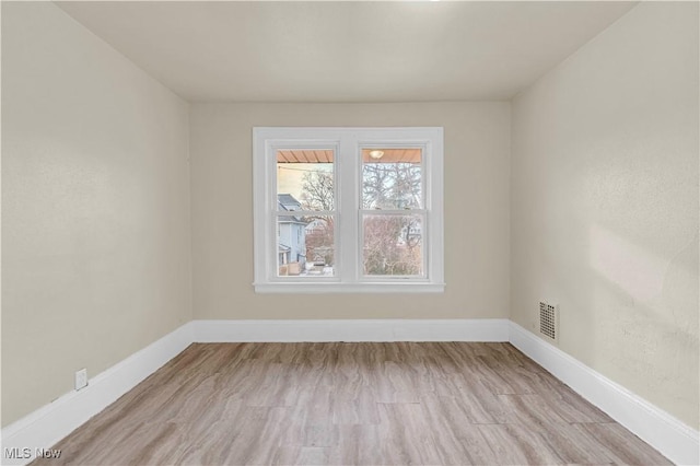 unfurnished room with light wood-type flooring