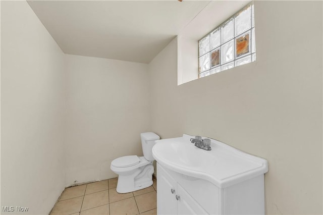 bathroom with vanity, toilet, and tile patterned flooring