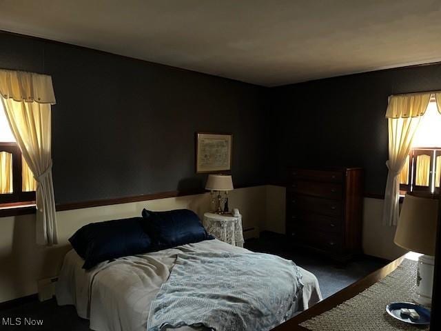 bedroom featuring dark carpet