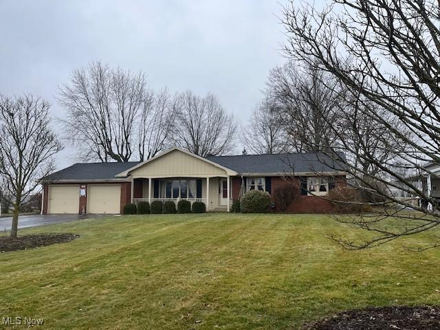 ranch-style home with a garage and a front yard