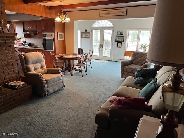 living room with french doors, beam ceiling, an inviting chandelier, and light carpet