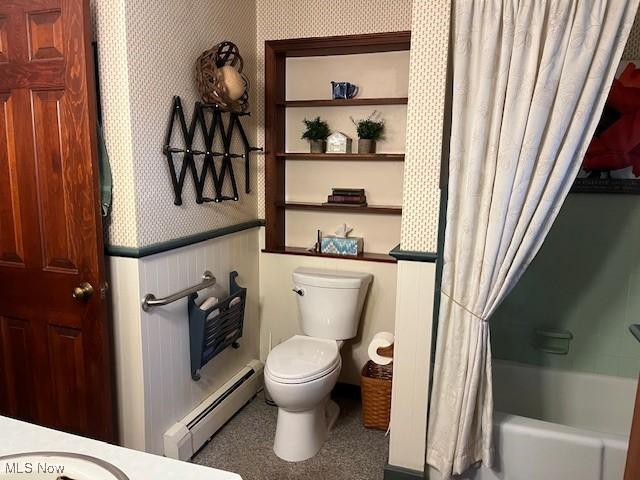 full bathroom featuring toilet, vanity, baseboard heating, and shower / bath combo with shower curtain