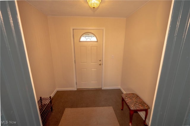 entryway featuring dark carpet